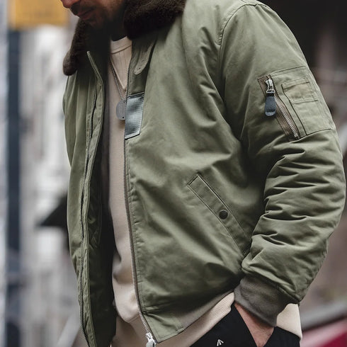 Person wearing a green jacket with a blurred background